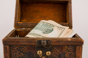 a paper money dollars in a wooden chest