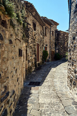 A street with a medieval, stone buildings