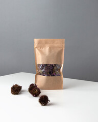 Brown kraft paper doypack bags with dried berries and medical herbs. Packaging for foods and goods...