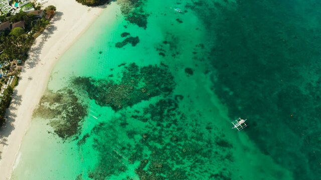 Tropical white sand beach, hotels near the blue lagoon and corall reef. aerial view, Boracay, Philippines. Seascape with beach on tropical island. Summer and travel vacation concept.