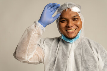 Asian Male wearing Personal protective equipment Suit and smile to the camera