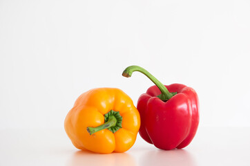 Red and Yellow ripe Bell peppers close up studio shot isolated on white