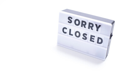 sorry closed,   words on lightbox on white background flat lay. 