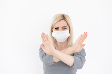 Stop the virus and epidemic diseases. Healthy woman in medical protective mask showing gesture stop. Health protection and prevention during flu and infectious outbreak.