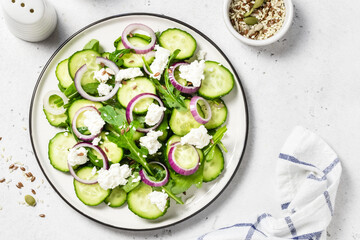 Feta red onion cucumber salad. Space for text, top view.