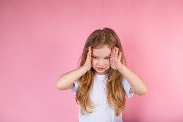 Portrait of a distressed child covering his eyes with his hands