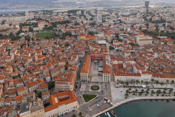 Aerial drone shot of Republic Palace by Diocletian Palace in Split old town before sunrise in morning