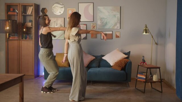 Teenagers womans shooting together dancing at home when making video for social media, stories hip hop popular trandy dance, students at home make content