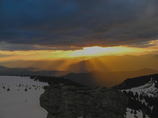 Beautiful landscape with high mountains with illuminated peaks , blue sky and yellow sunlight in sunrise.
