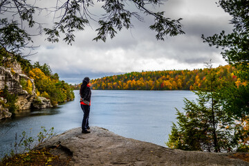 person in front of mountain top lake in autumn , Minnewaska State Park Preserve, New York