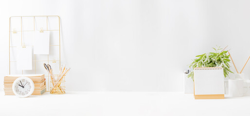 Home office desktop with mood board and empty card, books, desk calendar on a light background