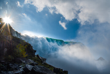 the sun over the top of Niagara falls