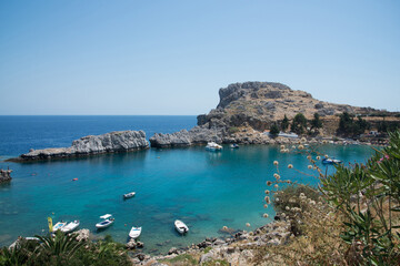 Beautiful bay close to Lindos, Rhodes, Greece. Many boats, blue water on a sunny day
