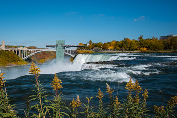 falls from the Niagara river with observation tower in the distance 