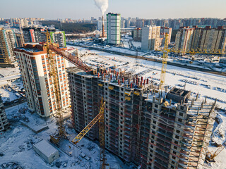 Fototapeta premium Aerial view of new constructions works on development site with high tower cranes. Building Real Estate.