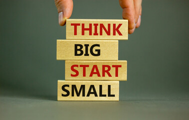 Think big start small symbol. Concept words 'Think big start small' on wooden blocks on a beautiful...