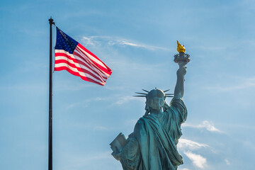 statue of liberty with America flag waving 