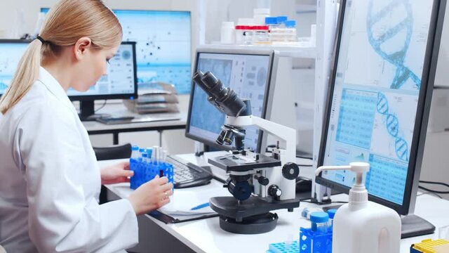 Professional team of scientists is working on a vaccine in a modern scientific research laboratory. Genetic engineer workplace. Future technology and science.