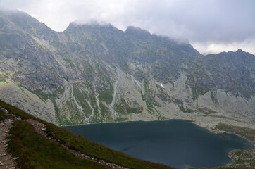 Fototapeta na wymiar Mountain lake Velke Hincovo pleso under peak Mengusovsky stit in Mengusovska valley in the national park of High Tatras - Slovakia