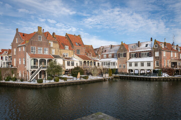 Scenic view of the old Dutch city residential buildings from the other side of the canal in winter