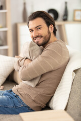 Obraz premium young attractive smiling guy resting on sofa