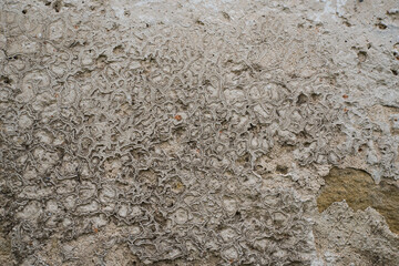 The texture of the old stucco on a brick wall.