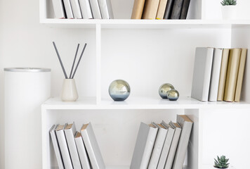 white bookshelves and minimalist design and incense sticks