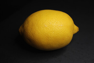 Lemon on a black background with reflection 