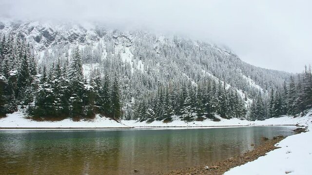 Amazing winter landscape with snowy mountains and clear waters of Green lake (Gruner see), famous tourist destination in Styria region, Austria