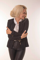 Joyful girl stands on white background and smiles.