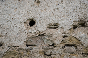 The texture of the old stucco on a brick wall.