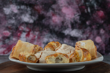 Caucasian traditional cookies with sugar powder in a white ceramic plate