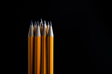 group of pencils isolated on pure black background