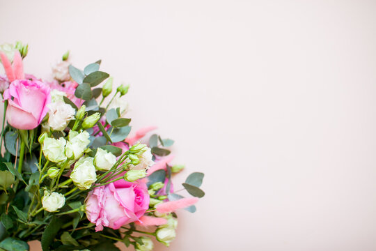 Delicate touching bouquet of white and pink flowers on a light pink background. Layout. Flat lay