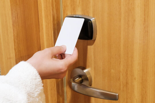 Close up woman hand opening a door by key card in the hotel. 