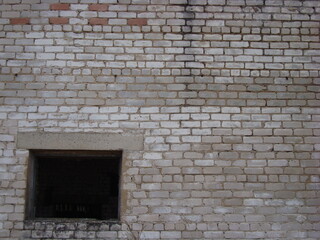 Window opening in a white brick wall