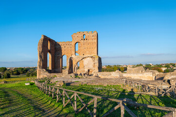 The Imperial Villa dei Quintili, the thermal baths and the caldarium on the Via Appia in Rome, on a beautiful day of blue sky a suggestive panoramic image of the brick building.