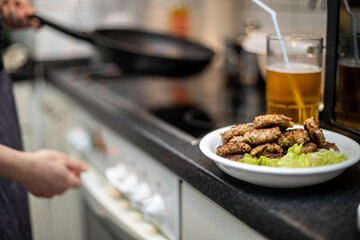 woman preparing mini hamburger over the kitchen table