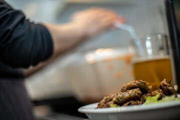 woman preparing mini hamburger over the kitchen table