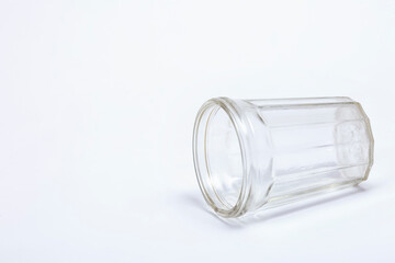 Faceted glass lying on white background