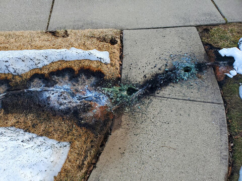New Milford, NJ USA - Feb 16 2021: Live wire falls on residential street - burns so hot that it melts through the sidewalk and turns the sand underneath to glass. Reddit #1 on r/all 2-17-21