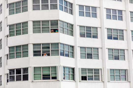 People without balconies cope with the pandemic lockdown through their windows at the Four Ambassadors Apartment Building, Miami, Florida