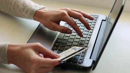Female hands holding credit card making online payment. Woman consumer paying for purchase in web store using laptop technology. Ecommerce website payments concept.