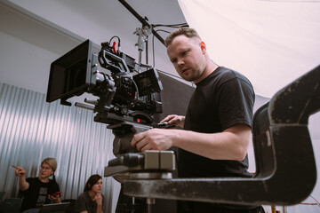 Director of photography with a camera in his hands on the set.