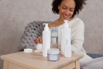Woman applying moisturizing cream. Selective focus on Skin care Products,copy space