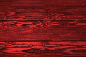 A fragment of a red wooden plank