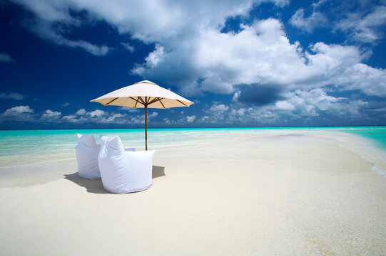 Two Lounge Chairs and Parasol on empty Beach, The Maldives, Indian Ocean