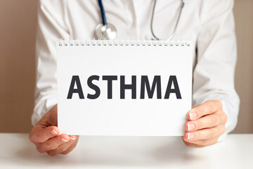 Doctor holding a paper plate with text ASTHMA, medical concept