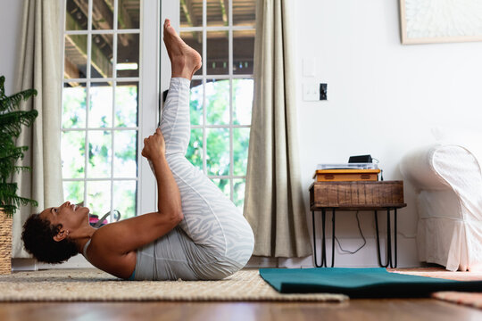 African American woman doing palates core strength training at home