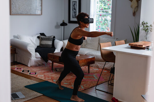 Black Woman Does Boxing Exercise At Home Using Virtual Reality Technology